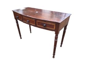 A nineteenth century bowfronted mahogany side table with three boxwood strung cockbeaded knobbed
