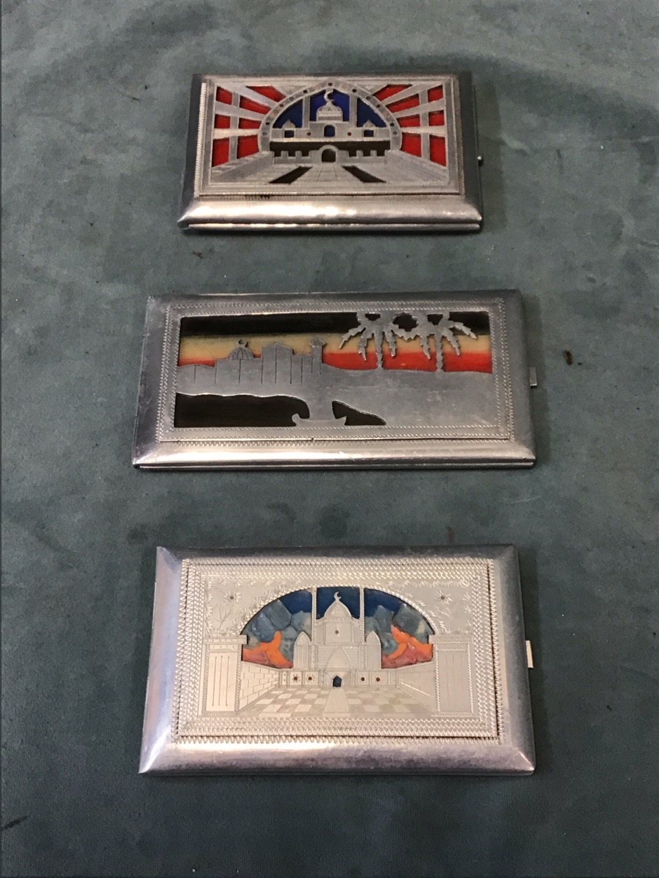 Three 40s Egyptian aluminium cigarette boxes, with pierced, painted and engraved decoration - one