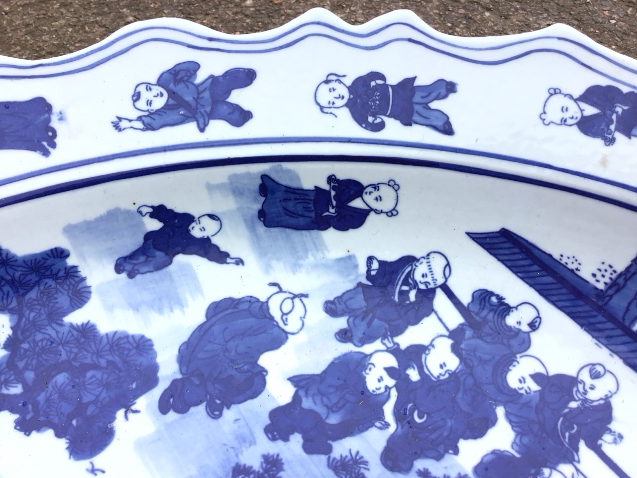 A large Chinese blue and white circular scalloped charger decorated with children in a garden amid - Image 2 of 3