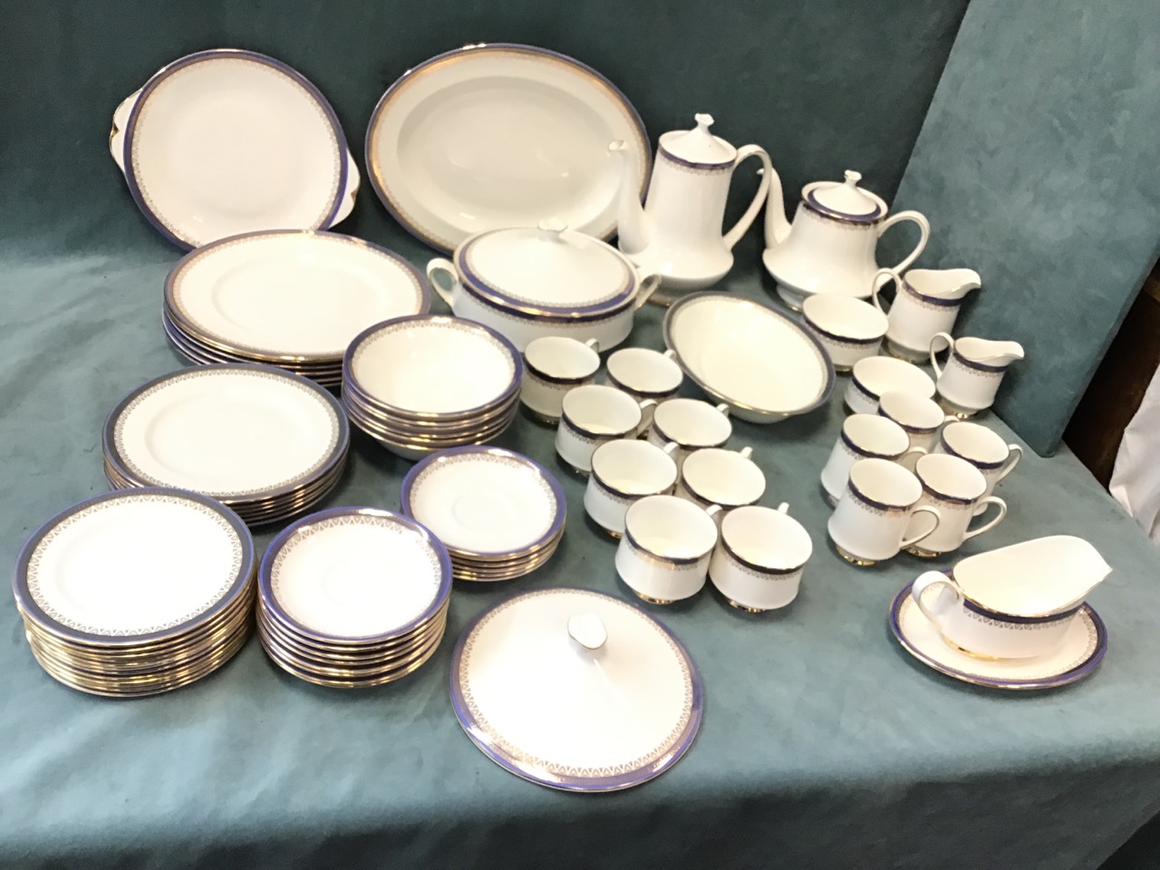 An extensive Paragon porcelain dinner/tea service with blue and gilt borders in the Sandringham