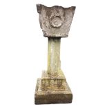 A large composition stone garden urn on square stepped moulded column, the tapering tub with waved