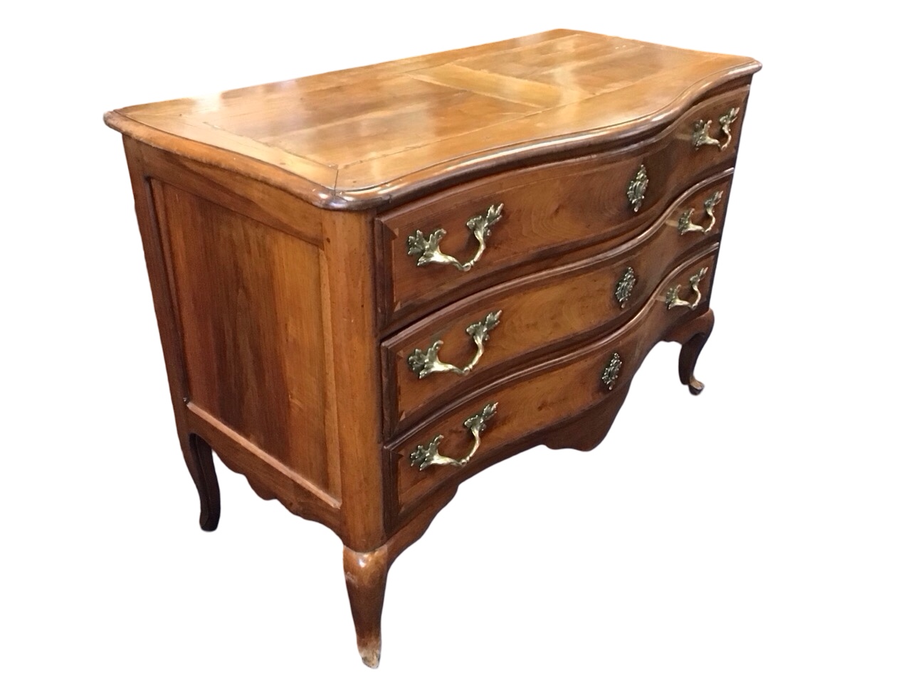 A C18th Italian serpentine fronted walnut commode, probably Piedmontese, with moulded rosewood