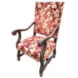 A European walnut C17th style open armchair with upholstered rectangular back and seat flanked by