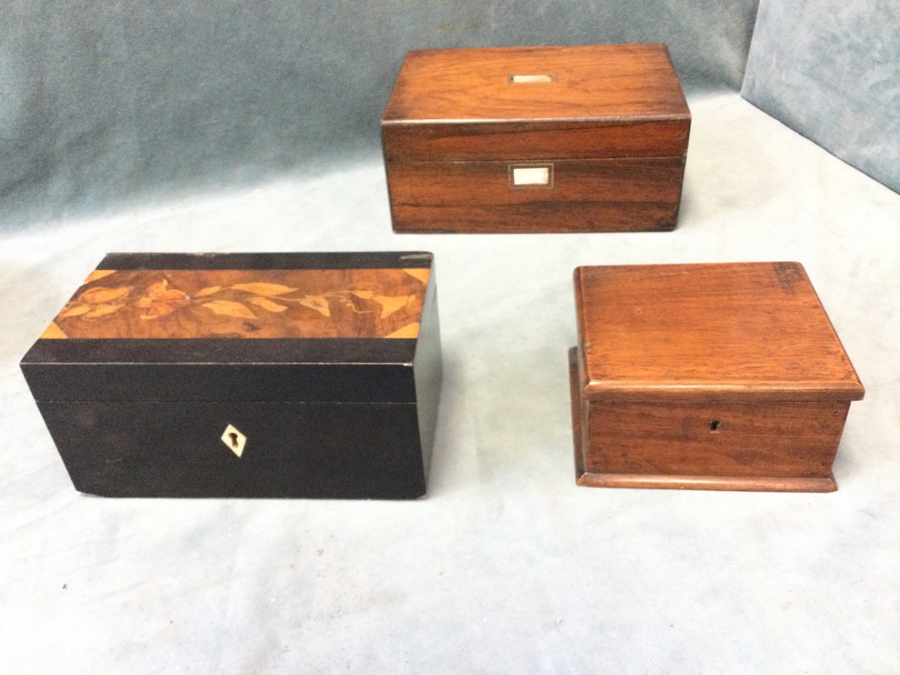 A Victorian ebony tea caddy with floral marquetry top; a rectangular C19th rosewood box with