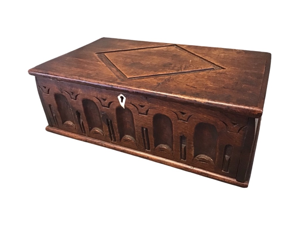 A rectangular oak bible box with lozenge carved cover and arcade chiselled frieze with bone