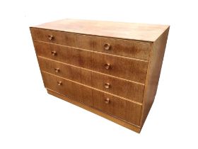 A 60s Meredew oak chest with two short and three long graduated knobbed drawers, above a recessed