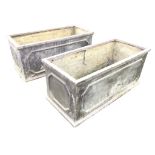 A pair of faux lead rectangular garden troughs with panelled sides and moulded plinths. (31in) (2)