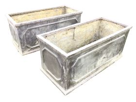 A pair of faux lead rectangular garden troughs with panelled sides and moulded plinths. (31in) (2)
