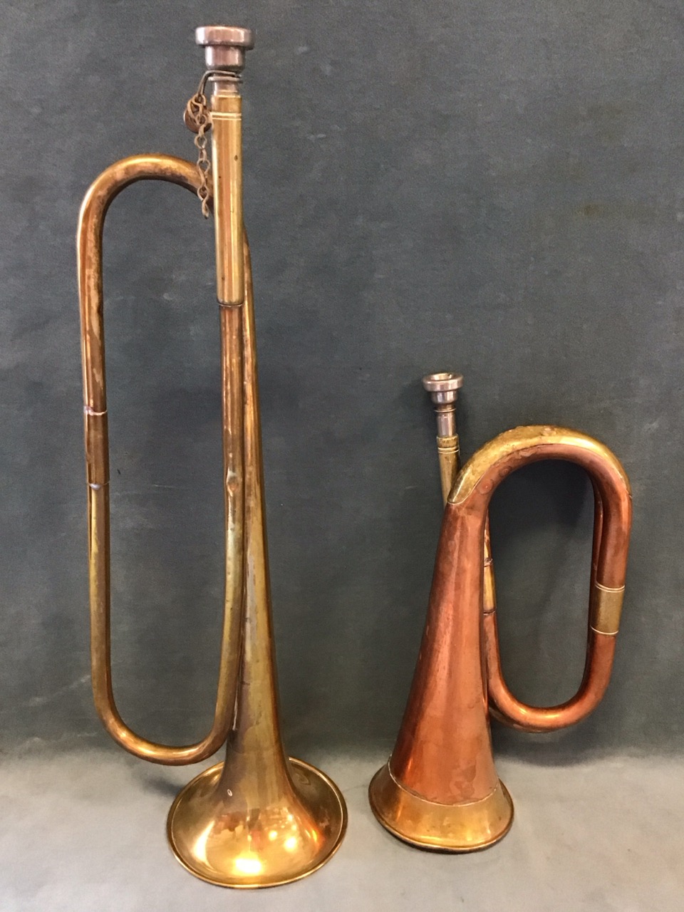 A brass valveless trumpet - 19.25in; and a copper & brass bugle - 12in. (2)