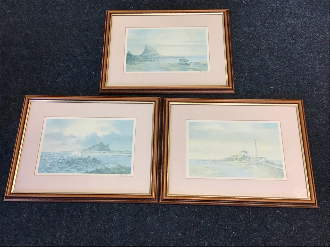D Fenwick, a set of three coloured prints, Northumbrian coastal scenes - St Marys Island, Bamburgh