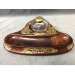 A Victorian walnut inkstand, with circular glass inkwell on a solid carved base with shaped pen