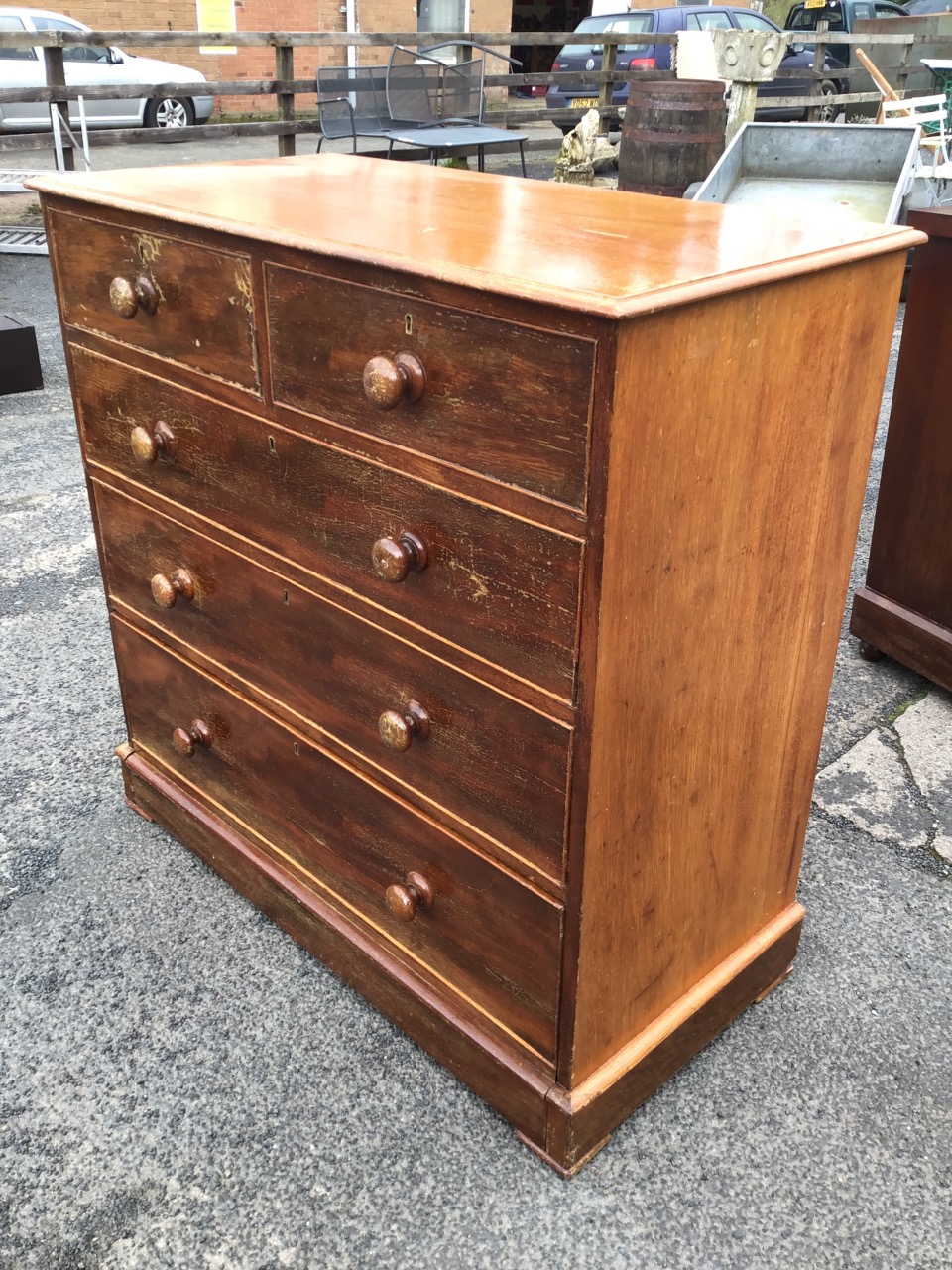 A Victorian mahogany chest of drawers with moulded top above two short and three long knobbed