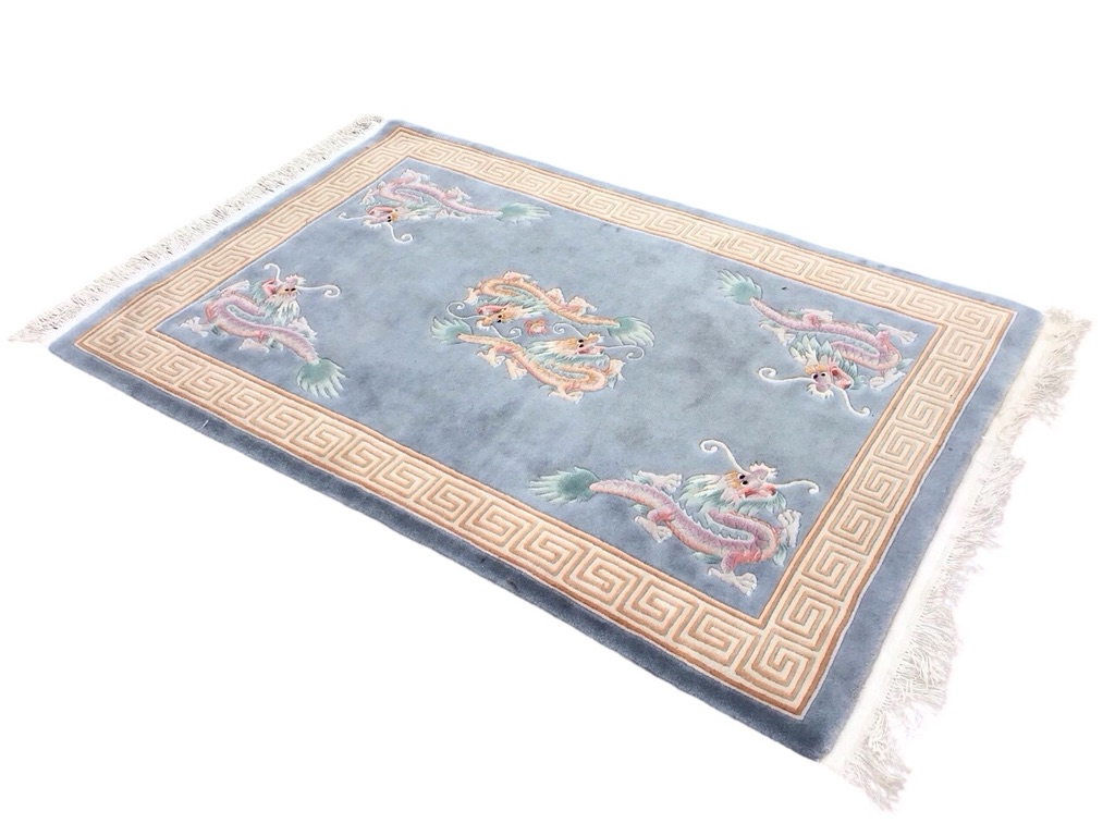 A Chinese rectangular wool rug with central medallion of dragons chasing the pearl and dragon