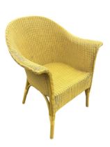 A Lloyd Loom style wicker tub chair, the arched back and arms above curved rectangular seat,