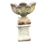 A composition stone garden urn on stand, with scalloped leaf moulded pot on square base with