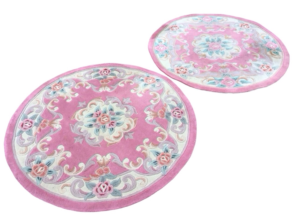A pair of circular Chinese wool aubusson style rugs with central floral medallions on pink grounds