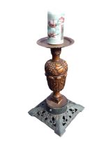 An oak acanthus carved candlestand with copper tray top on column carved with fruit, the cast iron