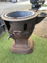 A Victorian cast iron boiler - The Thistle, with cauldon shaped flat rimmed vessel having copper tap