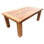 A heavy pine kitchen table with thick cleated rectangular pegged plank top on square column legs. (