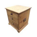A Victorian pine chest of three graduated knobbed drawers having carriage handles to sides, raised