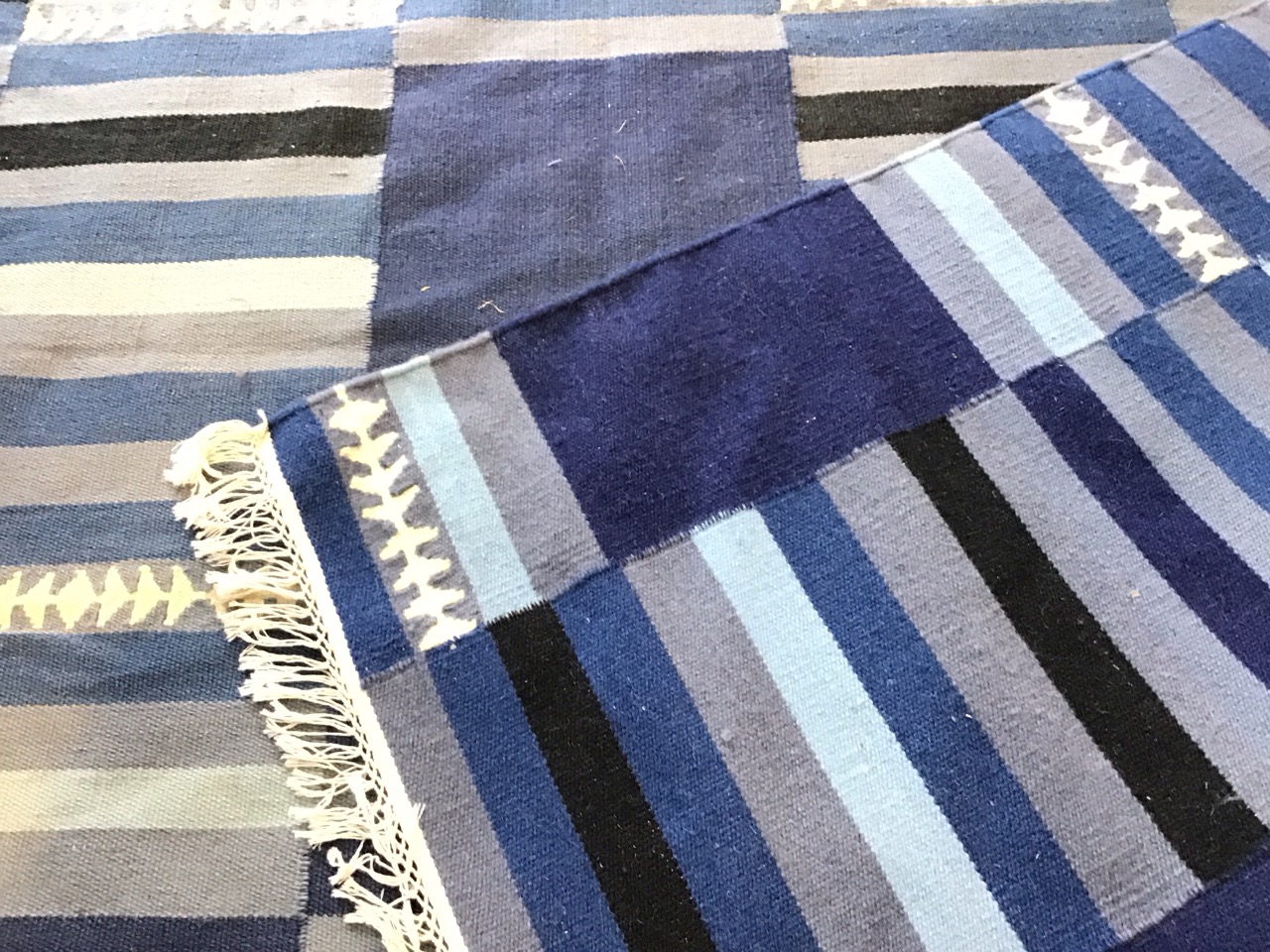 A contemporary wool kelim carpet woven with striped bands in shades of blue. (96in x 68in) - Image 3 of 3