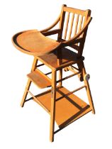 A 60s beech childs metamorphic high chair with rectangular slatted back above a solid seat flanked