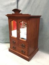 A late Victorian mahogany table cabinet having crest carved with initials BR, the scalloped mirrored