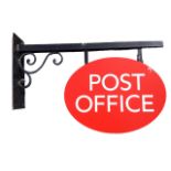 A contemporary oval metal post office sign on scrolled bracket with rectangular wallplate. (32.5in)
