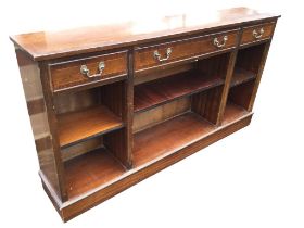 A mahogany crossbanded side cabinet with three frieze drawers above open adjustable shelves framed