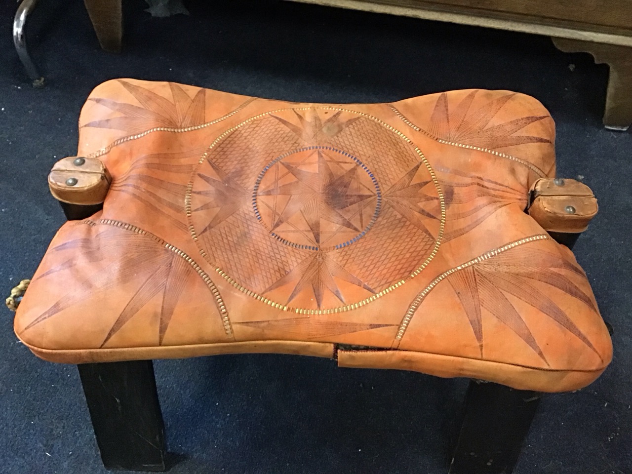 An Eastern camel saddle stool with loose leather cushion seat on a hinged folding hardwood frame, - Image 2 of 3