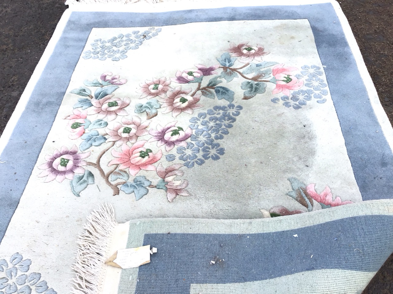 A rectangular Chinese wool rug with asymmetrical peony and blossom motifs on a pale blue ground - Image 3 of 3