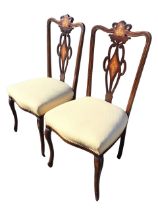 A pair of Edwardian mahogany side chairs, the scrolled backs and pierced splats inlaid with