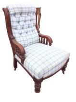 A Victorian mahogany upholstered armchair with rectangular buttoned back and bowfronted sprung