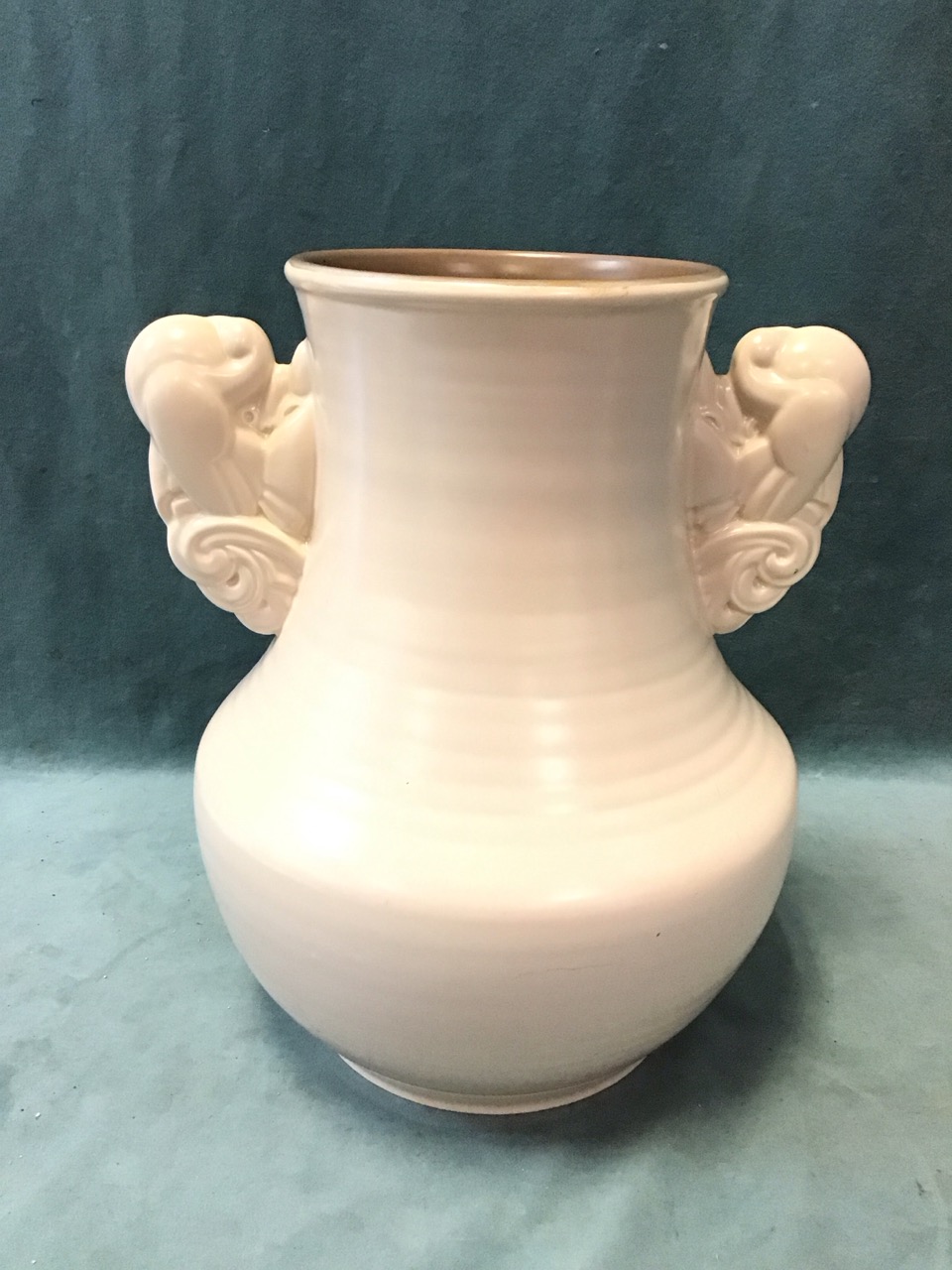 A large Poole Pottery art deco vase with hemispherical body and flared neck having applied moulded