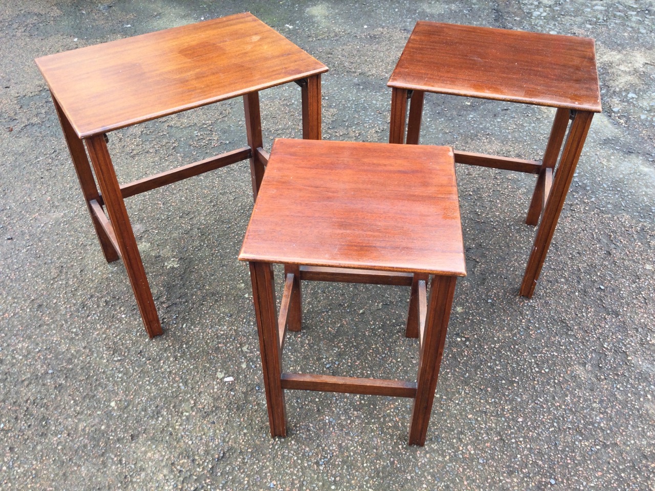 A mahogany nest of three tables with rectangular tops raised on grooved square legs joined by - Image 3 of 3