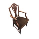 An Edwardian mahogany Hepplewhite style armchair, the shield shaped back with carved pierced splat