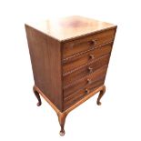 A mahogany music cabinet with five moulded knobbed drop-down drawers, raised on cabriole legs. (20in