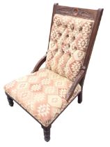 An Edwardian mahogany upholstered chair with foliate carved crestrail and rectangular buttoned