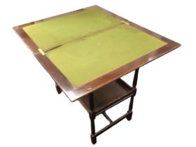 An Edwardian mahogany fold-over card table with rectangular tray top enclosing a baize lined surface