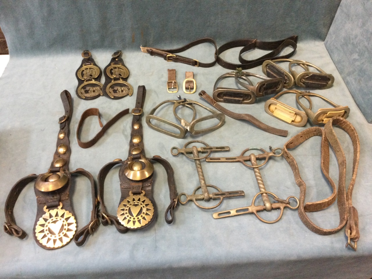 Miscellaneous horse tack - bits, pairs of stirrups - one dated 1914, straps/belts, horse brasses
