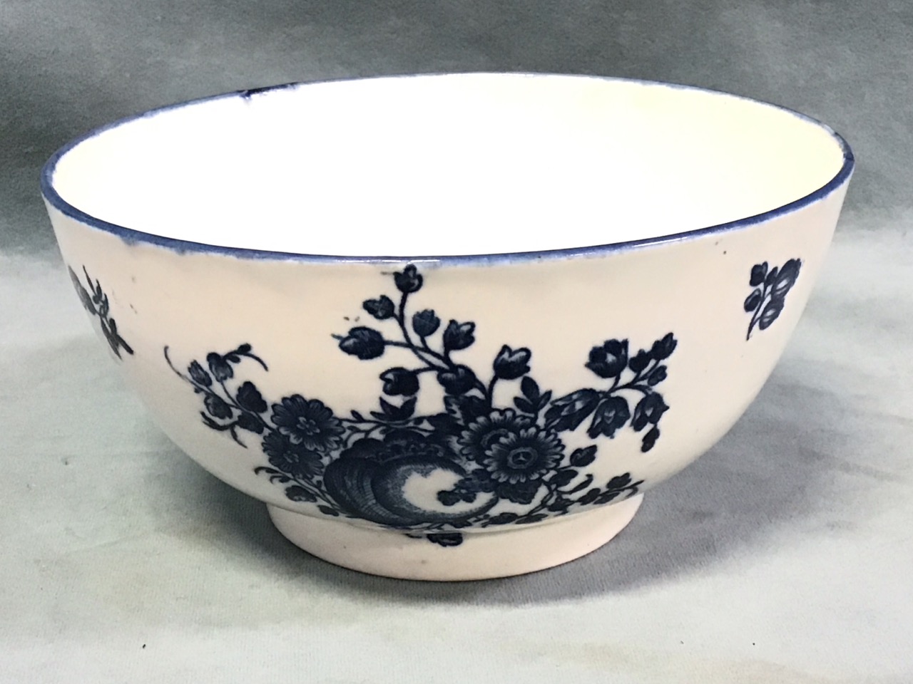 An C18th Caughley blue & white porcelain bowl decorated in the peach pattern - S mark. (6in)