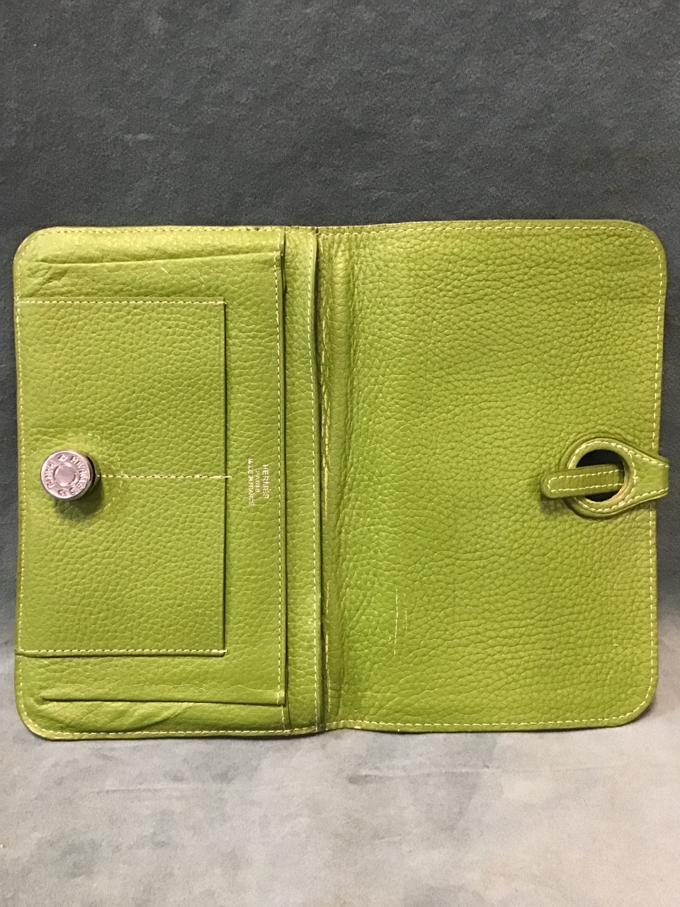 An olive green Hermès leather wallet, with dual compartments & card holders, having metal and - Image 2 of 3