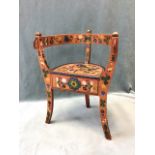 A Norwegian folk art childs chair with horseshoe shaped back and arms above a semicircular seat with