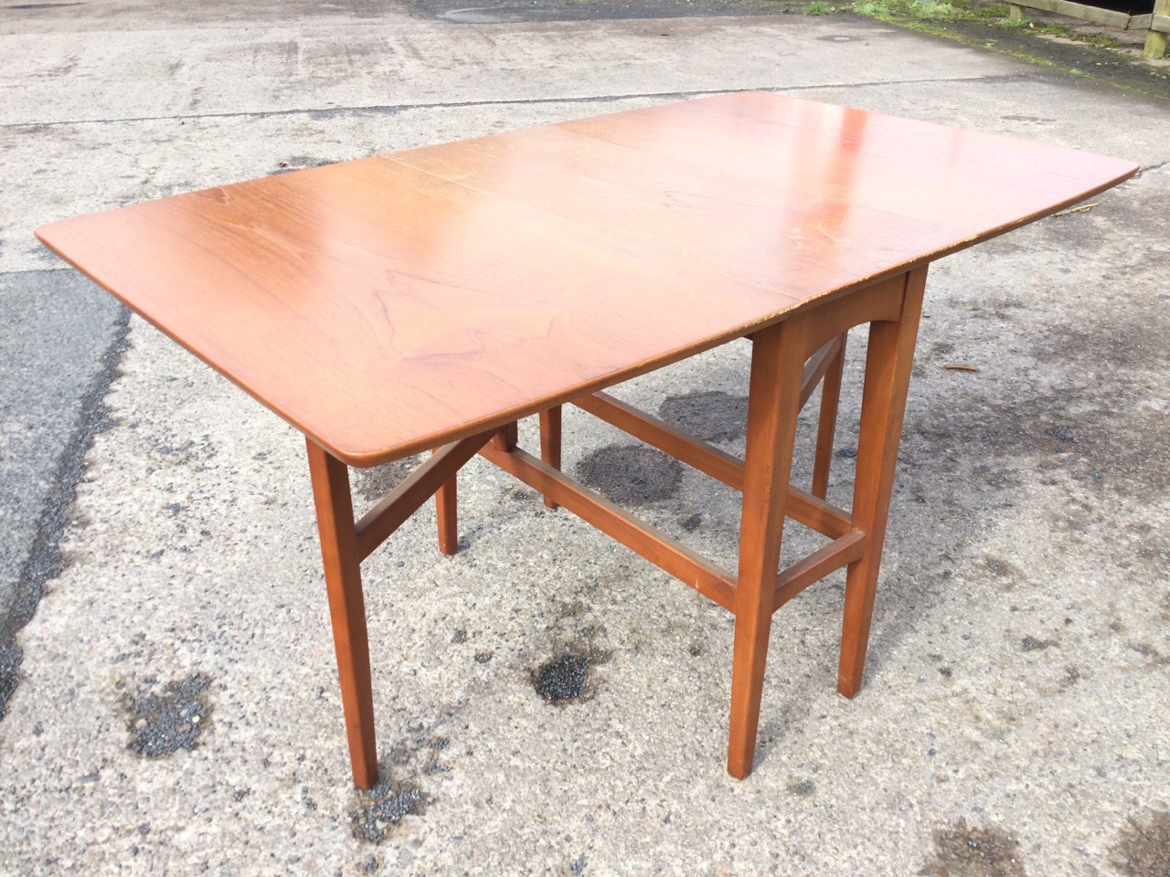 A 70s teak gateleg dining table with curved rectangular top and two leaves opening on gates above - Image 2 of 3