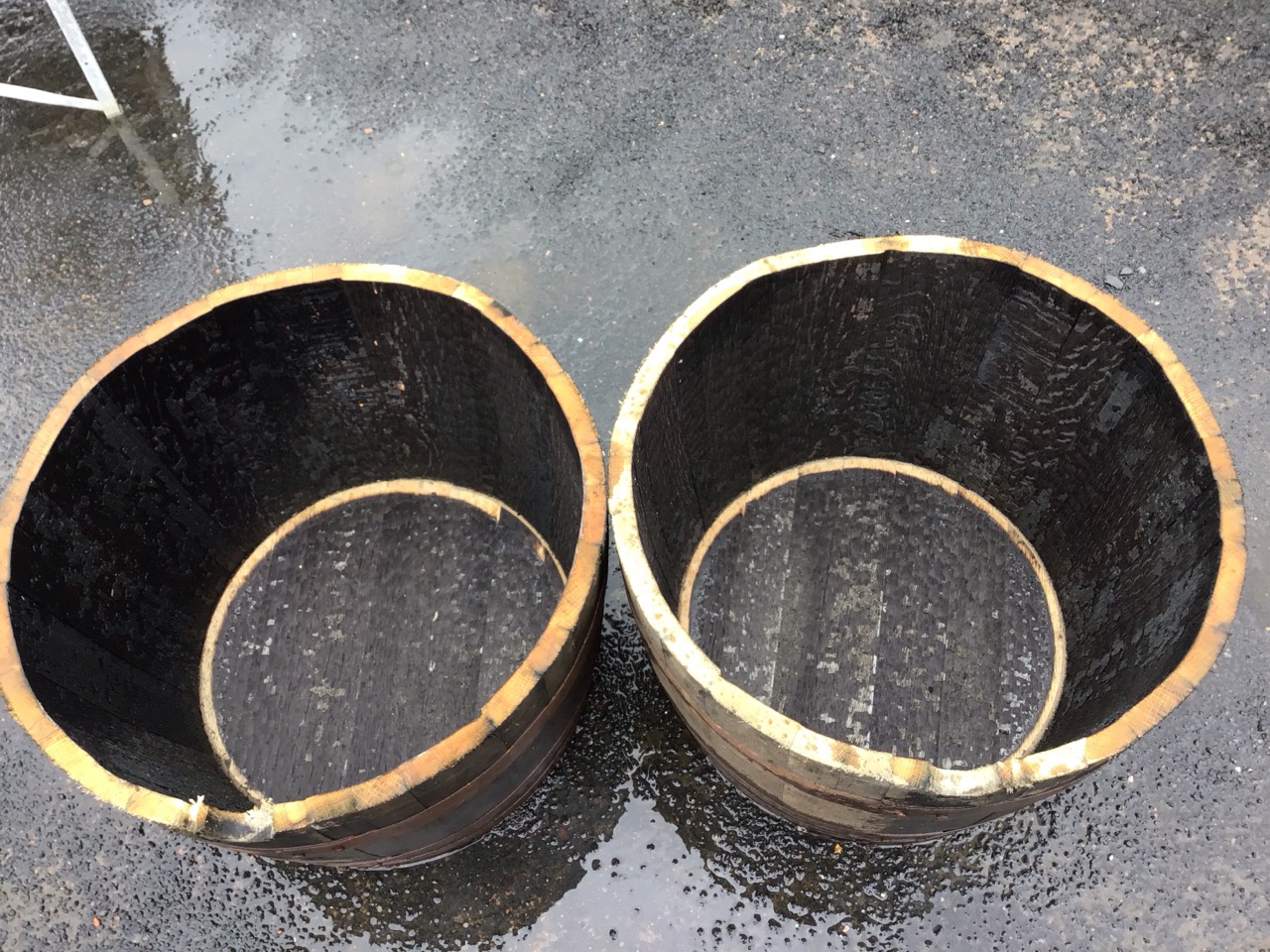 A pair of oak whisky barrel garden tubs, the staves bound by three riveted metal strap bands. (17. - Image 3 of 3