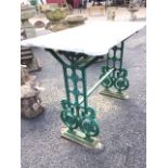 A marble topped garden table, the rectangular slab with rounded corners supported on a late