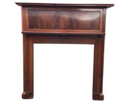 An Edwardian mahogany chimneypiece with moulded rectangular mantleshelf above a scalloped panel,