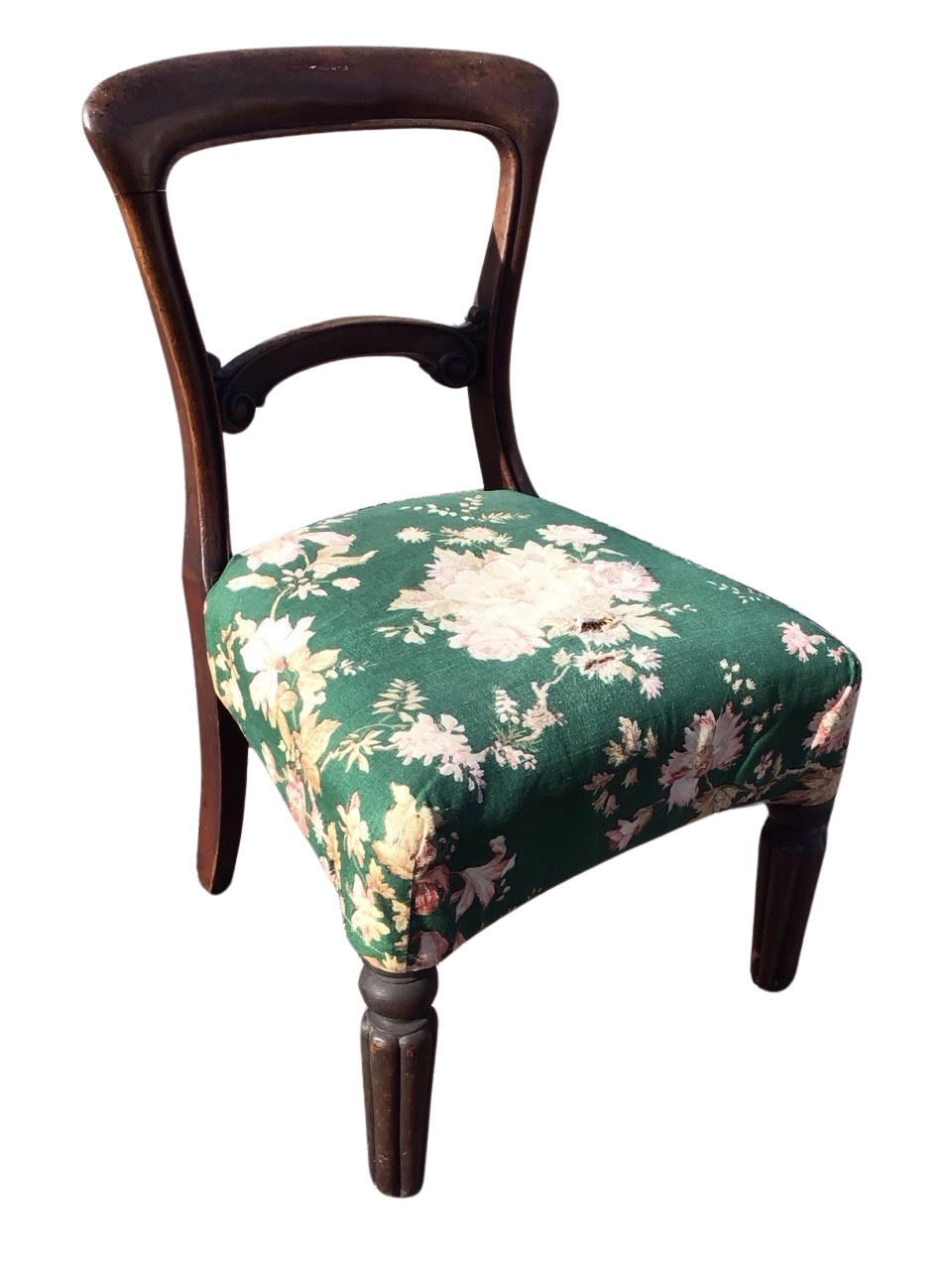 A Victorian mahogany dining chair with rounded back above a scroll carved rail and concave fronted
