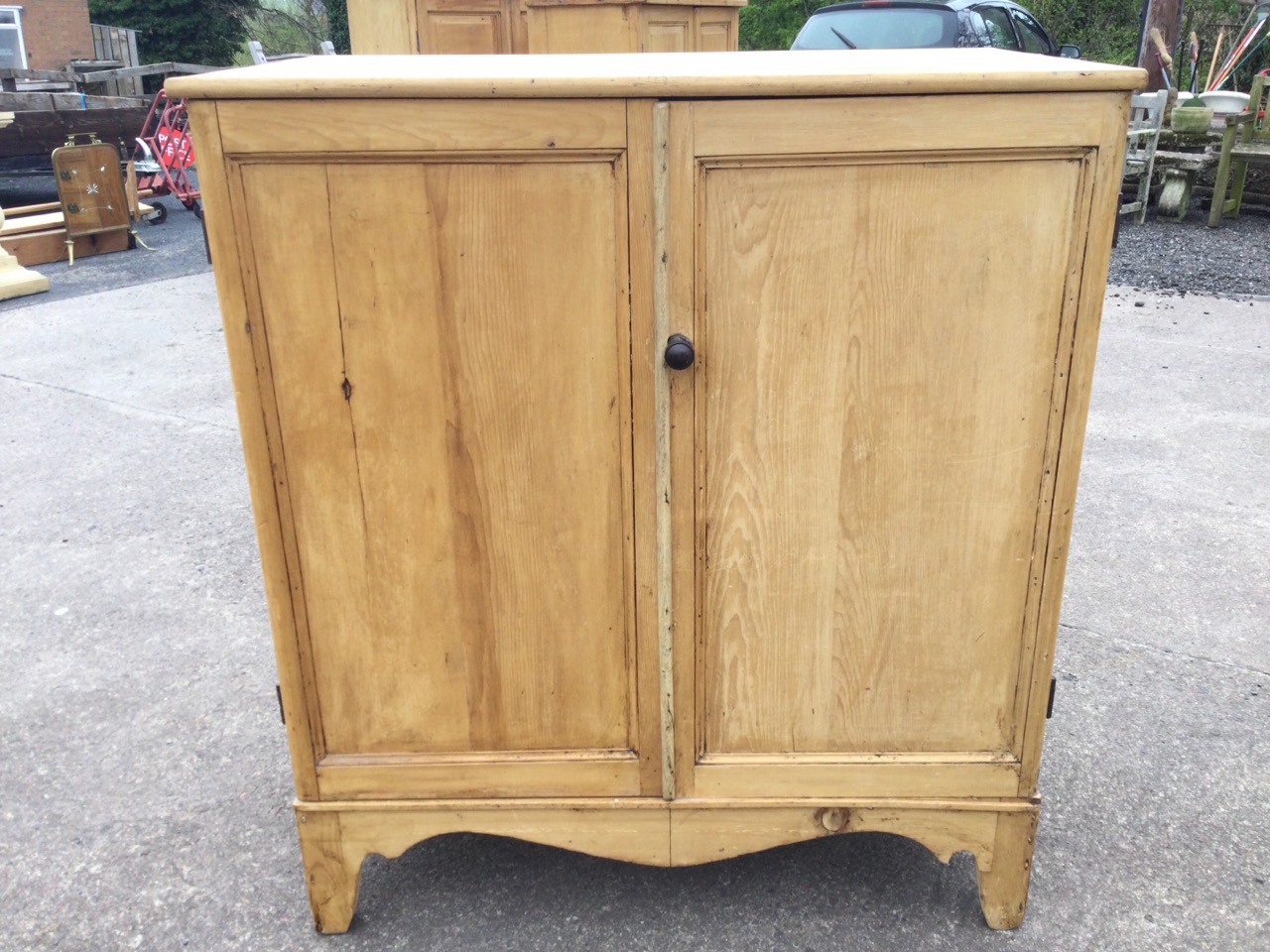 A Victorian pine cupboard with moulded panelled doors above a shaped apron, raised on bracket - Image 2 of 3