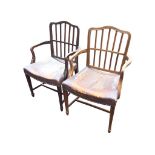 A pair of nineteenth century mahogany boxwood strung elbow chairs with rectangular spindles to